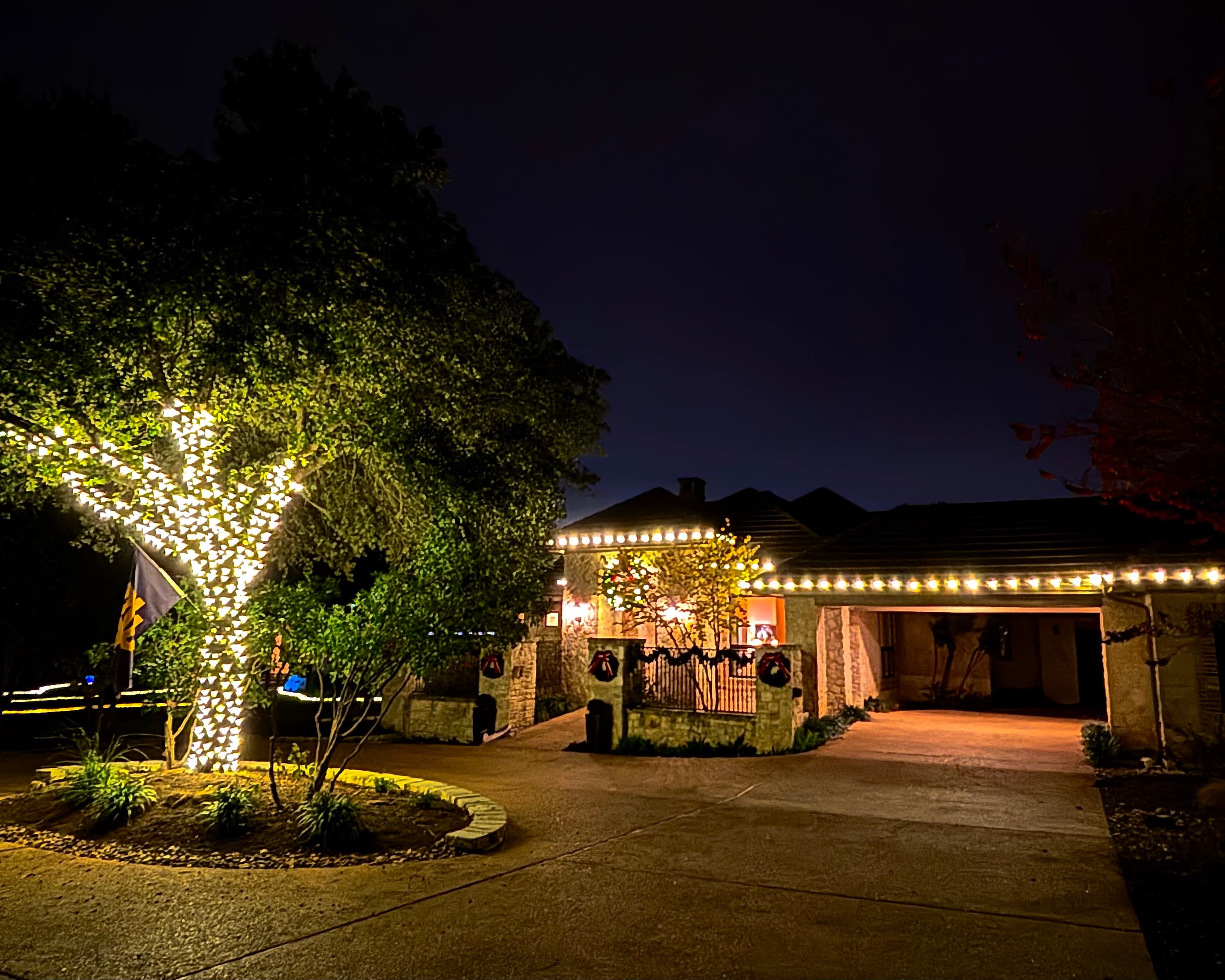 Twilight view of an Atlanta home with warm white roofline Christmas lights